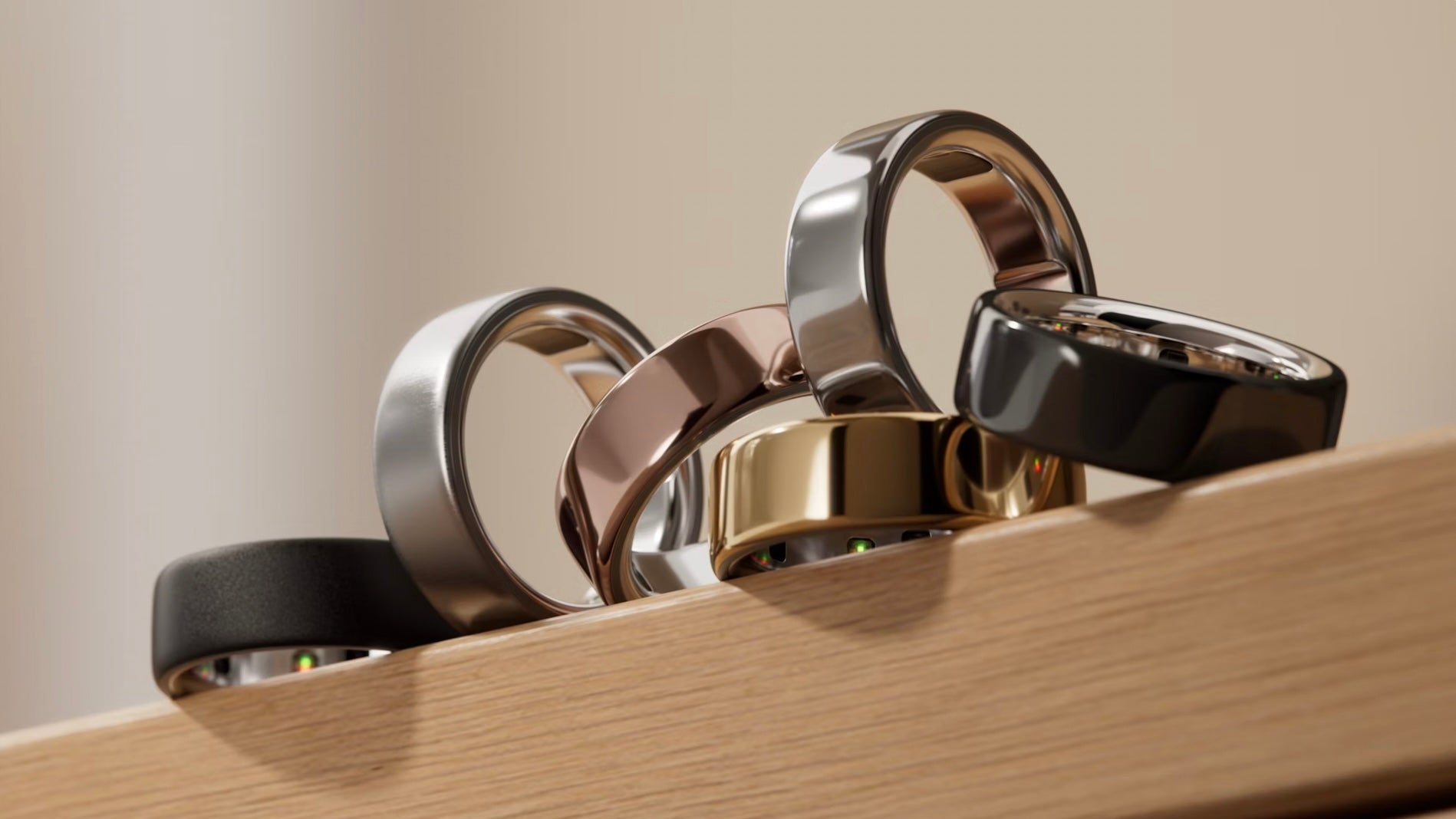 Set of metallic rings on a wooden surface with a neutral background